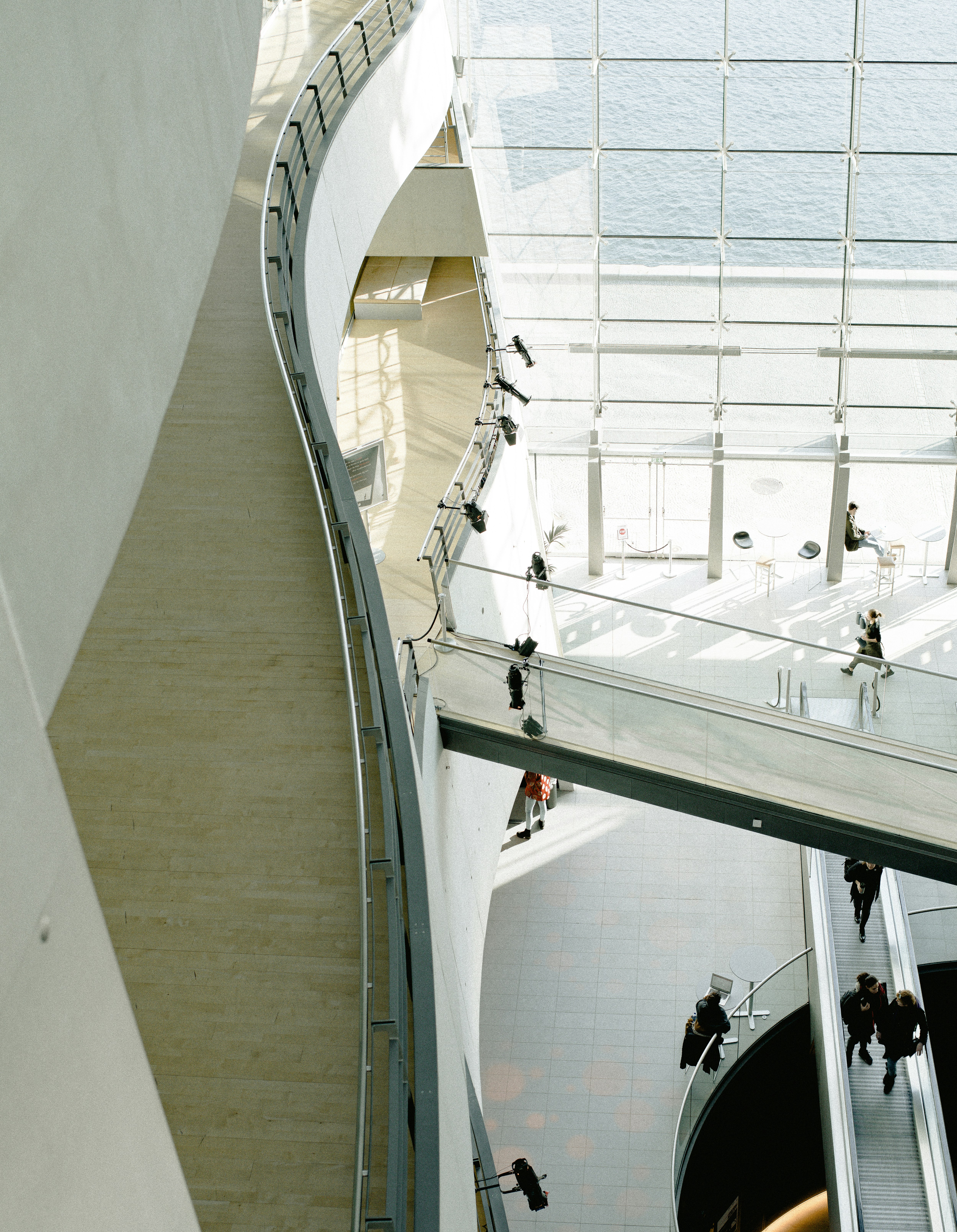 people walking inside white painted building